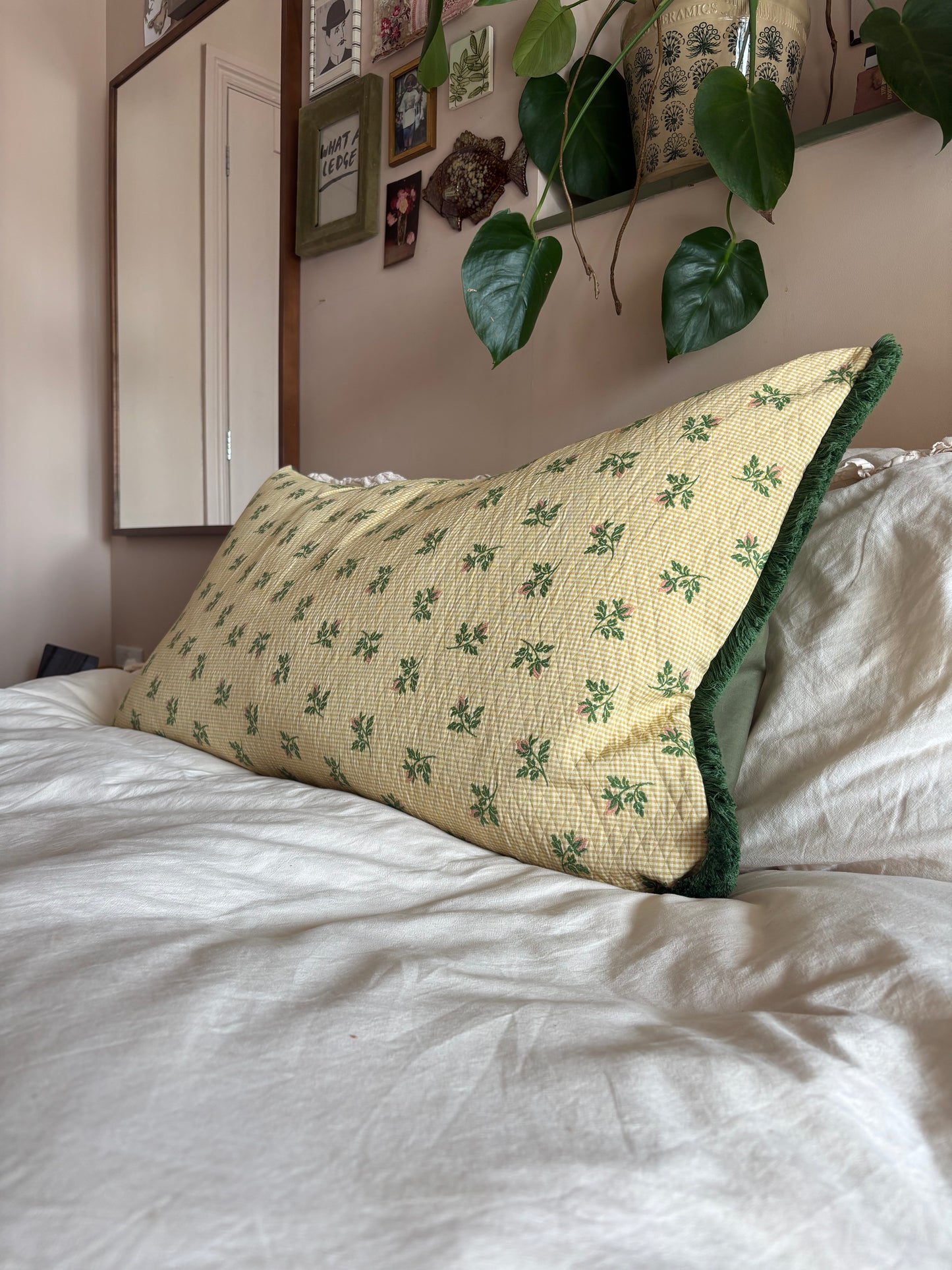 Embroidered fringed bolster cushion